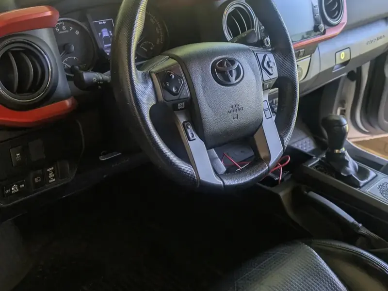 Detailed steering wheel and dashboard inside a Toyota pickup