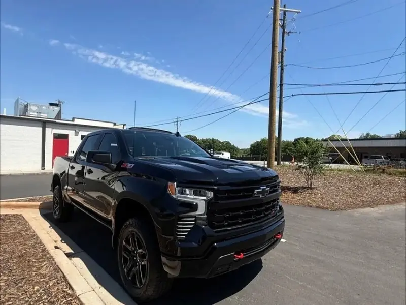 Black Chevrolet pickup after an exterior detail