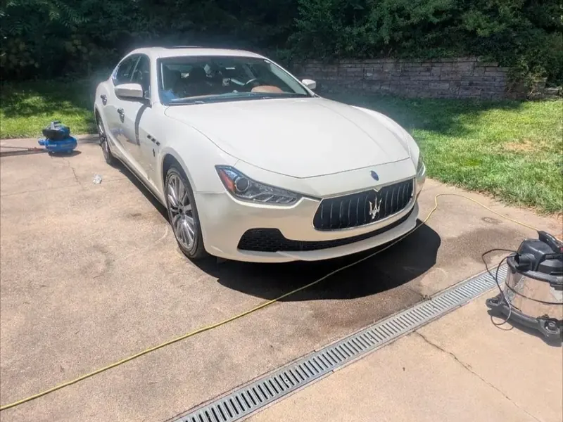 Glossy white Maserati sedan parked after detailing