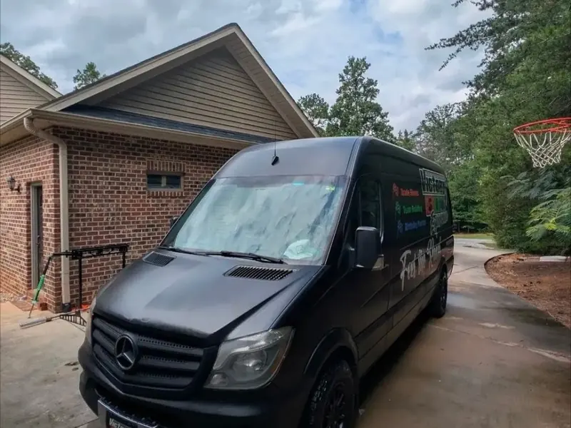 Black Mercedes Sprinter van detailed in a driveway