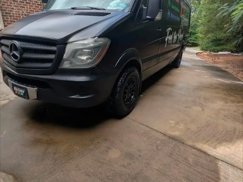 Black Mercedes Sprinter van, front, after a wash