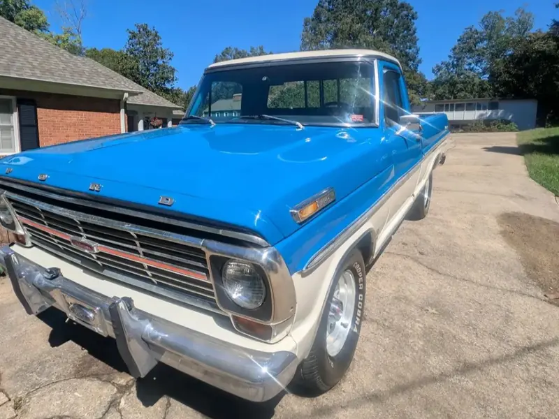 Blue and white vintage Ford pickup detailed in a driveway
