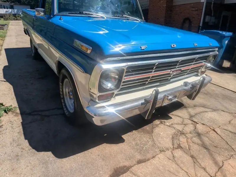 Blue and white vintage Ford pickup, front angle, after a detail