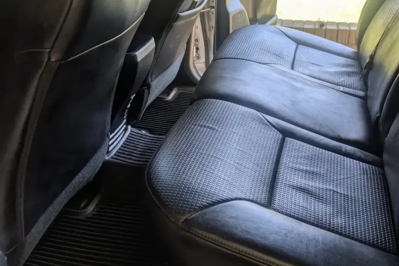 Black leather rear seat and floor mats cleaned inside a vehicle